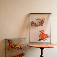 Tholu Bommalata puppets - tiger and leopard pair and Hamsa and checkered bird pair, shown mounted for display against a cream wall
