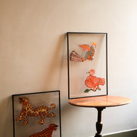 Tholu Bommalata leather puppets - two hand-painted pairs, animals and birds, shown mounted for display in a softly lit room