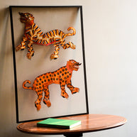 Tholu Bommalata puppets - striped tiger and spotted leopard in saffron, orange and black, shown mounted for display